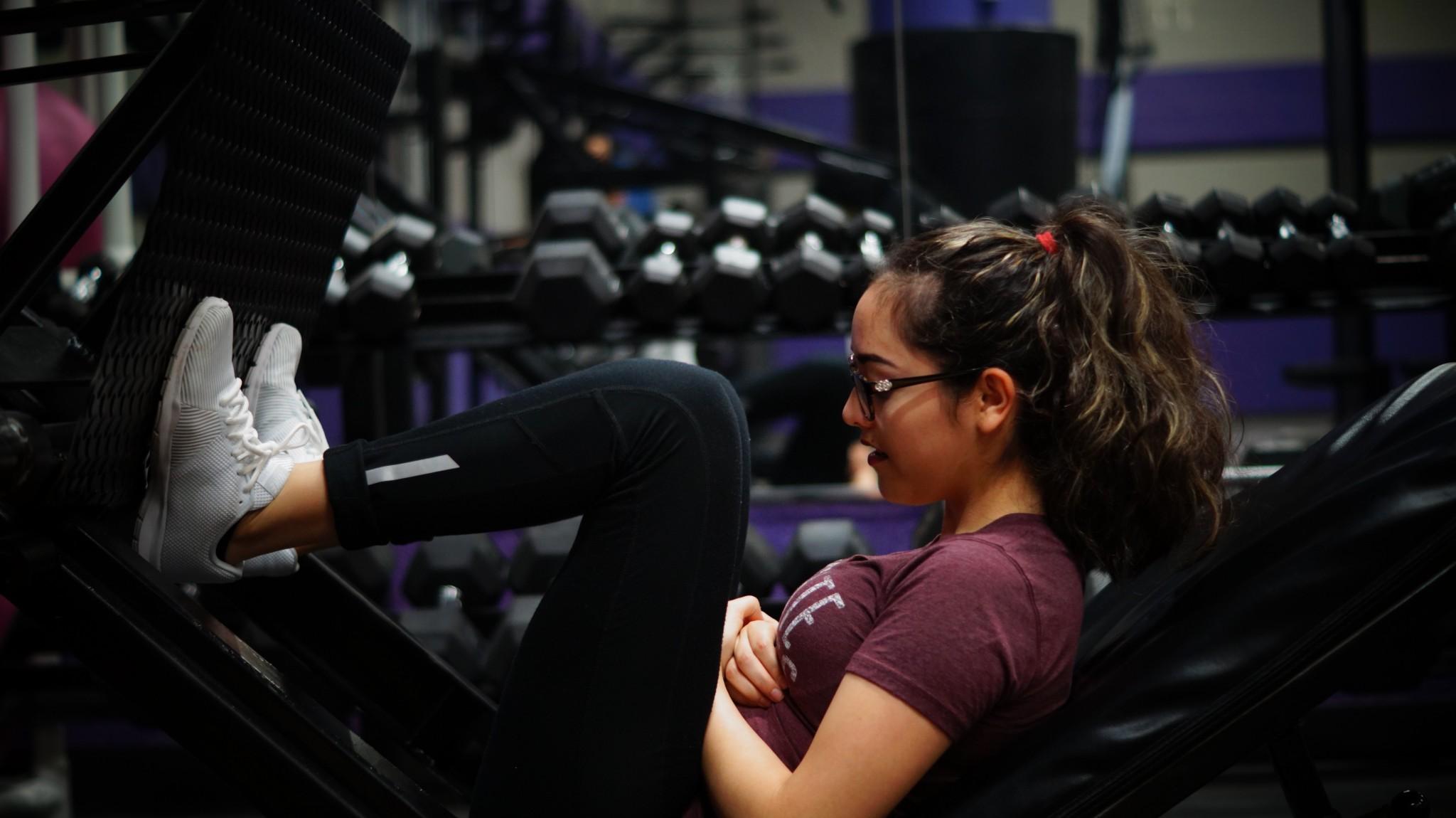 Senior Sabrina Murillo works out her knees and thighs with the leg press.
