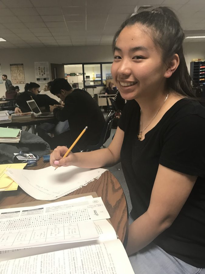 Junior Quynh Do working on test corrections during her AP Environmental Science class.