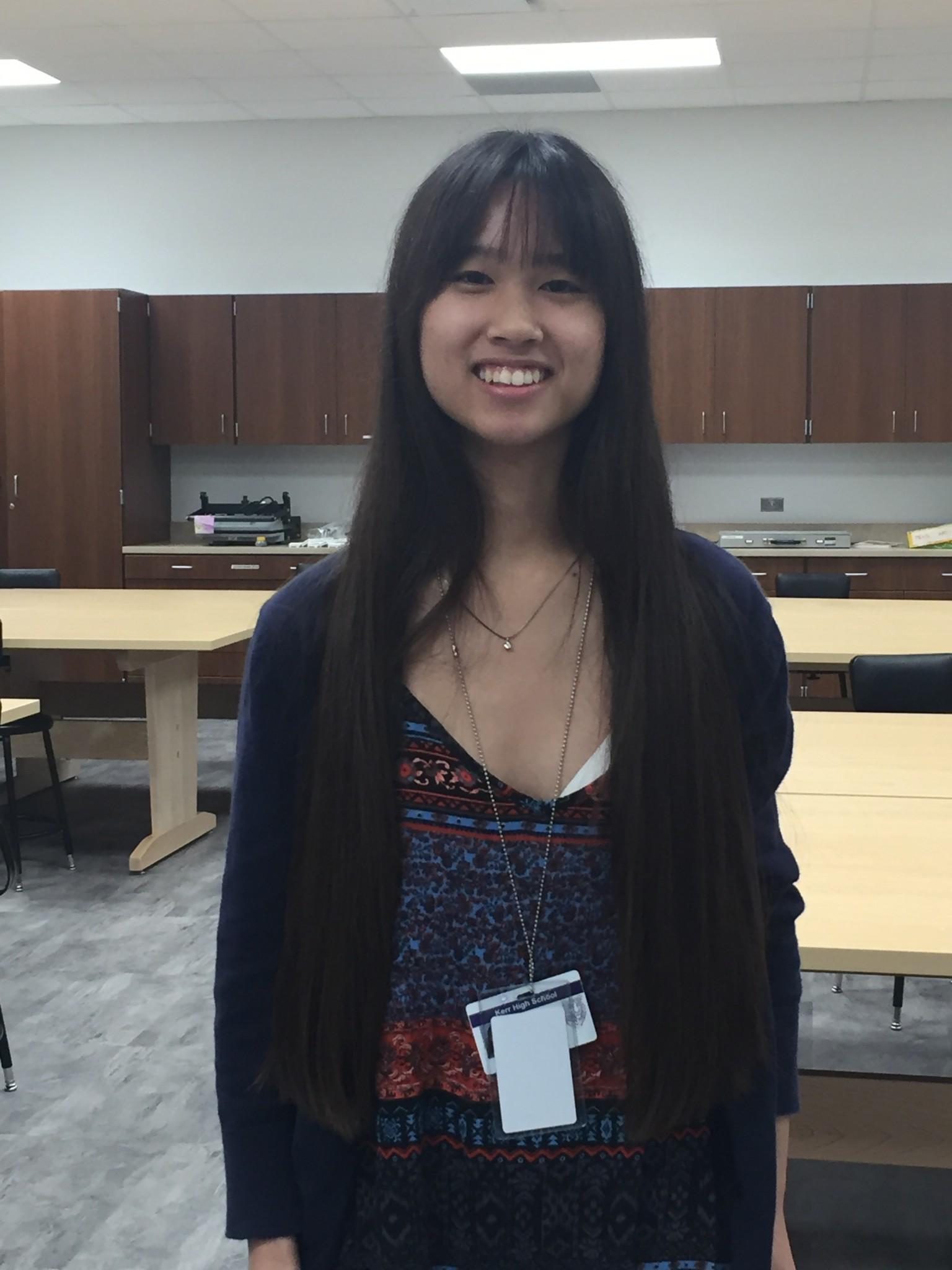 Junior Nhi Mong Chung poses for a feature photo in one of the art rooms in the new building.