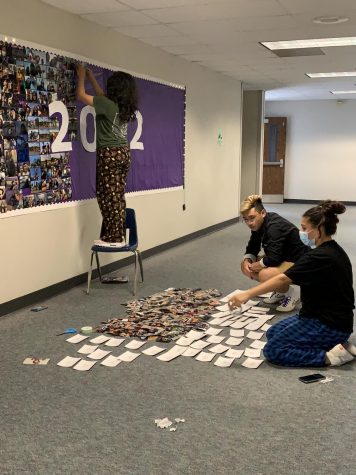 Seniors assemble the memory wall outside the library