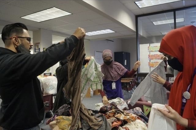 Mr. Ali and MSA members sorting out the clothes from donation to give to Afghan families in need.