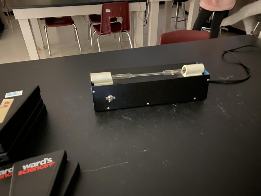 Look for the Light, Students in Pre-AP Chemistry looked at a high voltage emission tube with a spectroscope to observe line spectra.