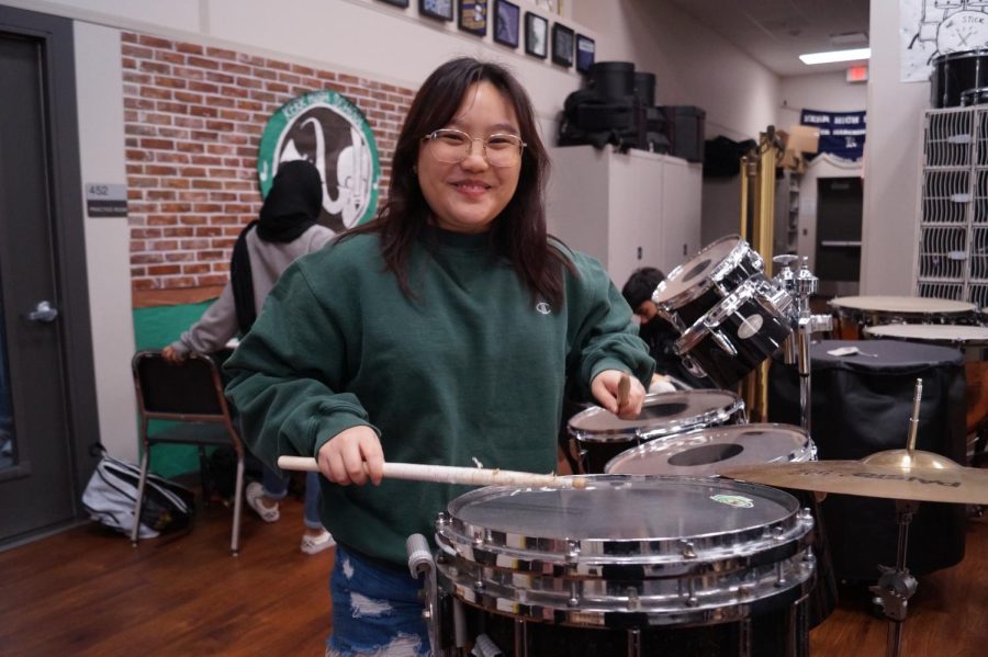 Wham! Amanda Choi plays the percussion instrument called the drums. I like hanging out here playing with the instruments.