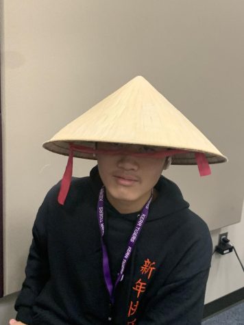 Aiden Le wearing an Asian rice hat.