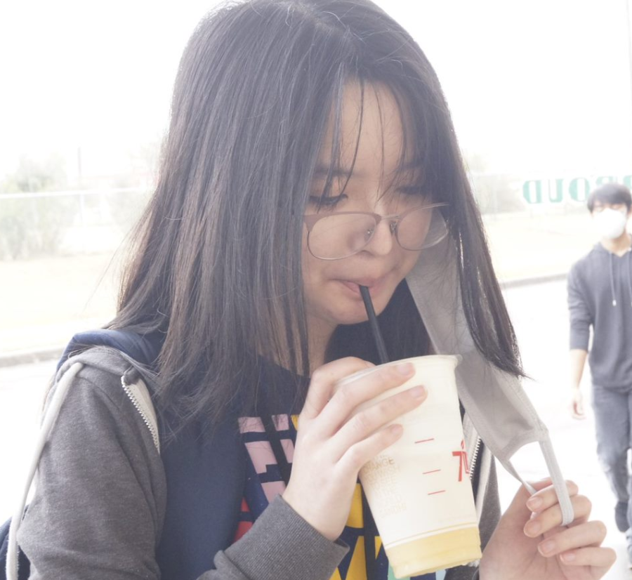 Jessica Dang drinking Boba on the bus canopy. 