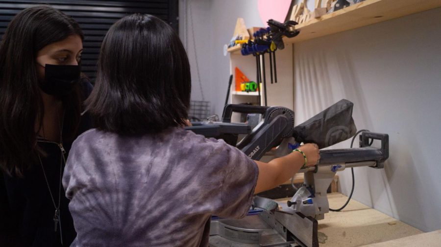 Saw It Out - The new set crew, Kelly Tran teaches another member how to use the saw. Camila Haro, even though not in set crew, she still wants to get the skills under her belt. It is not my first year in Cadre, but I want to learn as much as possible, before I get out of high school.