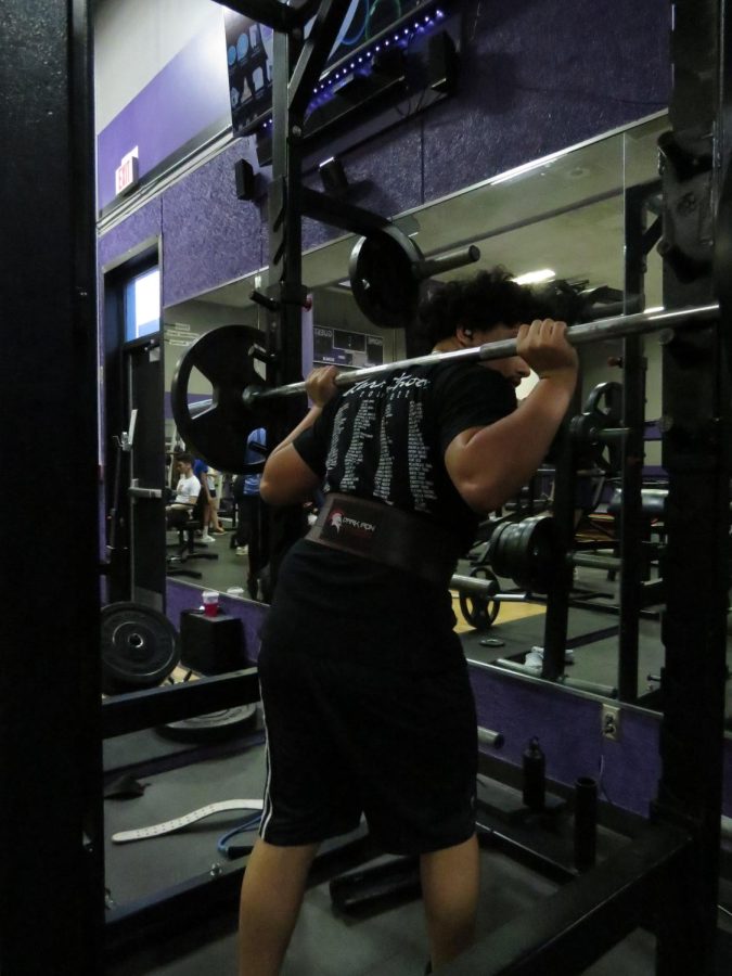 In this photo, Oscar is seen using the squat rack. He had just finished his third set and is re-racking the weight.
