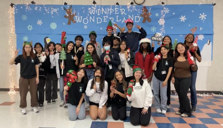 Student Council officers and executive board members take a picture in front of a backdrop at the Winter Wonderland social.
