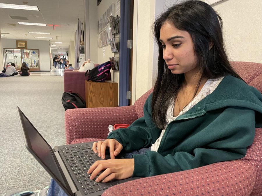 Tanisha Patel sitting at the jouralism study area, working on her assignments for World History.