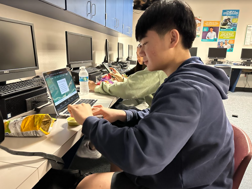 Johnny Luong is an academic weapon at Kerr High School. This image was taken in the computer science center. Luong is studying for an upcoming test while eating snacks from the Kubby Korner. He hopes to get a 100 on his new test. "I'll try my best- hopefully the results show!" Luong said. 