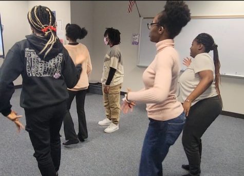 Kerr Dance Society officer, Clare Nneji, teaches members for the multicultural dance festival. In room 411, KDS members learn Wo Da Mo by Boy Spyce, Mavins, and Rema. 