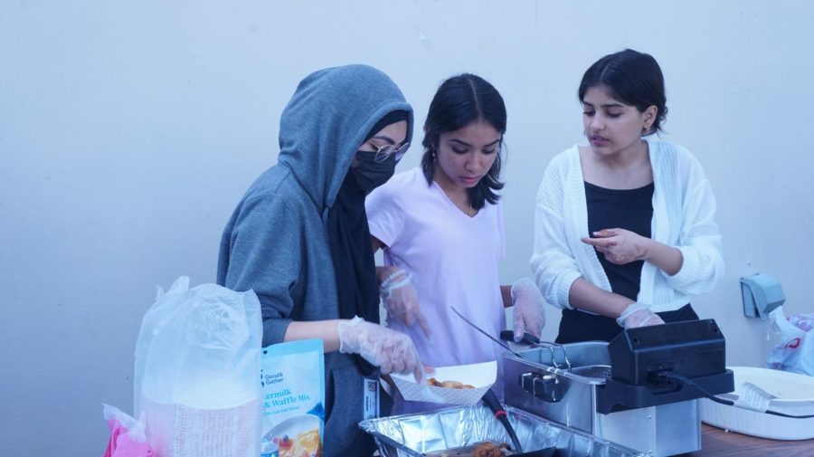 Desi Club members and officers work together to sell fried Oreos despite the power outage. I was the one frying the Oreos and, when the power went out, we were all stressed but still ended up selling a lot, Tanisha Patel, a Desi Club member, said.