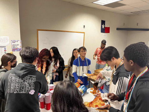 Ending the school year, Math Club members prepare food and eat with other members as they talk about the events of the past year.