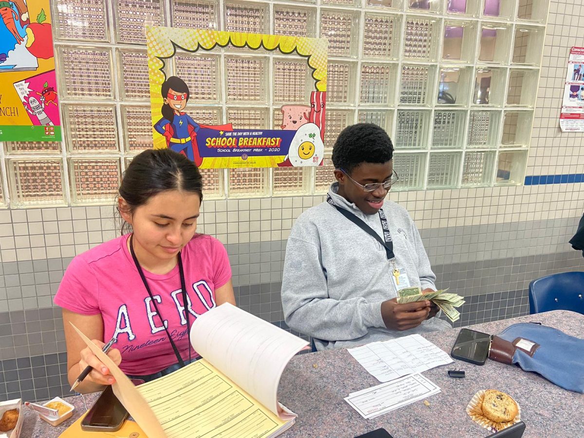 Counting Moolah. Officers Kunmi Oboh and Belen Peraza collect homecoming player fees during lunch. They had fun meeting with and explaining the information to new players. Im really excited to get this year started, Belen Peraza said.