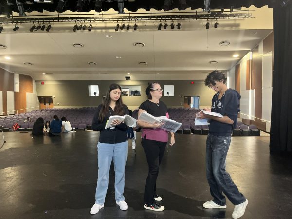 Speed Running It: Director Ryan, Junior Camilla Haro, and Sophomore Georgio Tahtouh go over the blocking of a specific scene. They are trying to clarify the blocking of a scene Haro and Tahouh are featuring in before all cadre actors attempt a group dance. “In theatre, to know where we need to stand on the stage, we do this thing called blocking. However, in dire times, we have to speed run them when we need more clarification,” said Sophomore actor and technician Gerogio Tahtouh.
