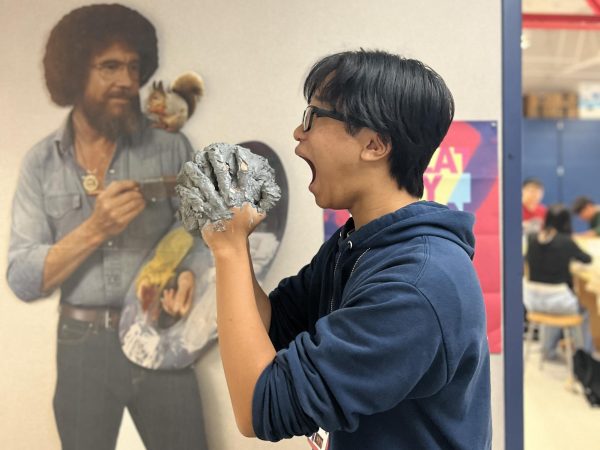 Benji Tran, who is currently taking AAC Art II Ceramic I, is seen enjoying playing around with a clay ball that he just created earlier for his ceramic project. It definitely tastes good, Tran said.