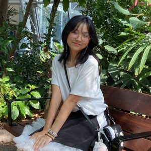A day at the museum. Minh Phan is visiting the museum with friends. She is resting at the bench in the butterfly exhibit. I was at the museum of natural science at the butterfly Exhibit. Said Phan.