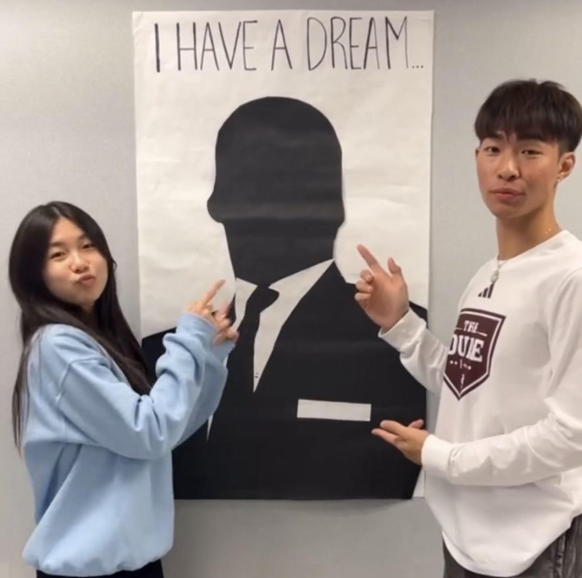 Senior Ryan Nguyen and sophomore Janet Duong advertise STUCO’s “I Have A Dream” poster near the library. Student council members are allowed to write one fact about Martin Luther King Jr. to earn one point.