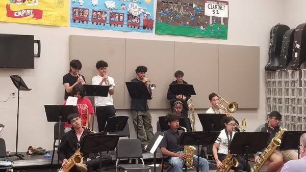 Kerr High School band players carefully rehearse their parts under the supervision of their teacher. Im determined to nail this solo - Ive been practicing it for hours, said one dedicated saxophonist.