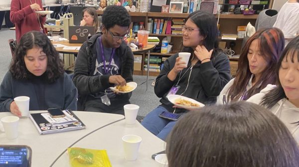 Nacho Time: Students enjoy nachos while playing a game of Quizizz. They were able to add their own toppings to their food. "We shared a meal together, which was a great way to connect and set the tone for the semester," Rebecca Oyeniyi said.
