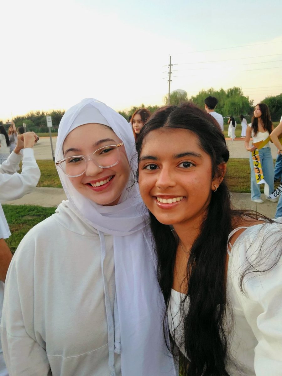 Good morning, sunrise! 
Seniors Sara Guerroudj and Alisha Rahman take pictures in front of the rising sun. They watched the sunrise with their classmates. “Senior sunrise was so exciting!” Guerroudj said. “So much so that I wasn’t even paying attention when the sun rose and completely missed it.” 
