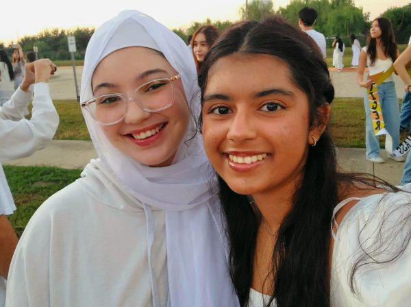 Good morning, sunrise! 
Seniors Sara Guerroudj and Alisha Rahman take pictures in front of the rising sun. They watched the sunrise with their classmates. “Senior sunrise was so exciting!” Guerroudj said. “So much so that I wasn’t even paying attention when the sun rose and completely missed it.” 
