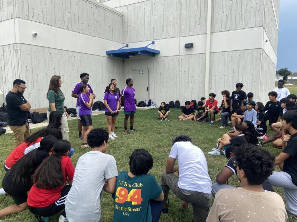 Game Face On: Vice President Maddeline Villatoro speaks to students gathered on the field. Villatoro welcomed everyone to the club and described what it takes to win competitions. "I'm so excited to work with everyone in this upcoming year,"  Villatoro said.