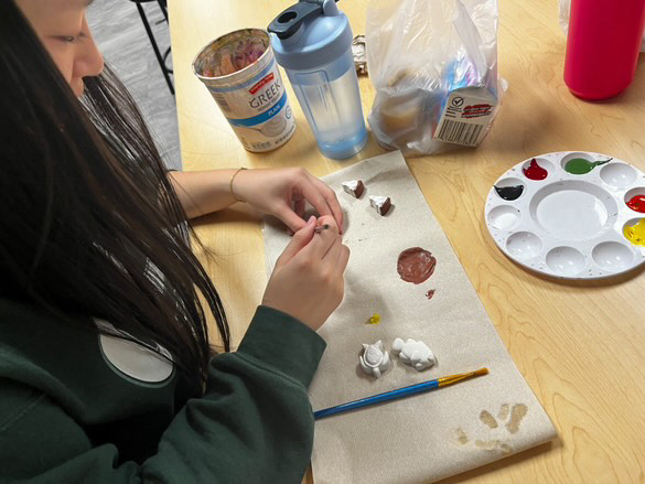 Calling all artists: Lisa Le paints different types of clay magnets. She plans to sell them at the Artwork Holiday Market with other members. "I plan to make paint seven different designs," Le said. 