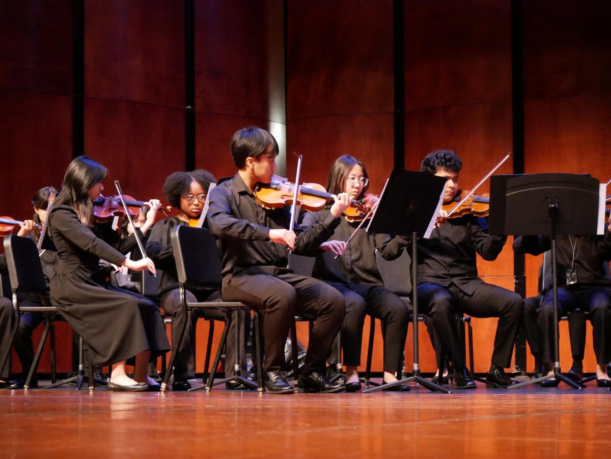 Orchestra Showcase: Orchestra students perform on stage at Taylor High School. They shared advice with Taylor students on improving their musical skills. “It was a rewarding experience to perform and inspire students at another school,"  Tony Luong said.