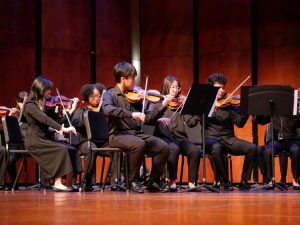 Orchestra Showcase: Orchestra students perform on stage at Taylor High School. They shared advice with Taylor students on improving their musical skills. “It was a rewarding experience to perform and inspire students at another school,"  Tony Luong said.