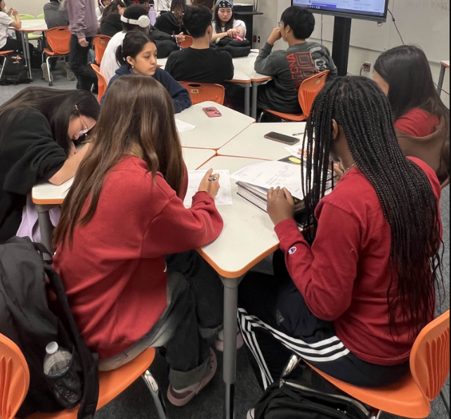 SAT Prep Session: Kerr Math Club members focus on their SAT practice worksheets, working through math problems to sharpen their skills. Students were given SAT problems as part of their preparation for the upcoming PSAT tests later in the week. In small groups, they collaborated to tackle each question, sharing tips and strategies for success. “The practice questions are really helpful for refreshing our memories,” Dylan Nguyen said.