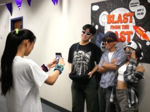 Yahan Dai takes a photo of Johnny Luong, Taylor Nguyen, and Connie Nguyen for homecoming dress-up week.

