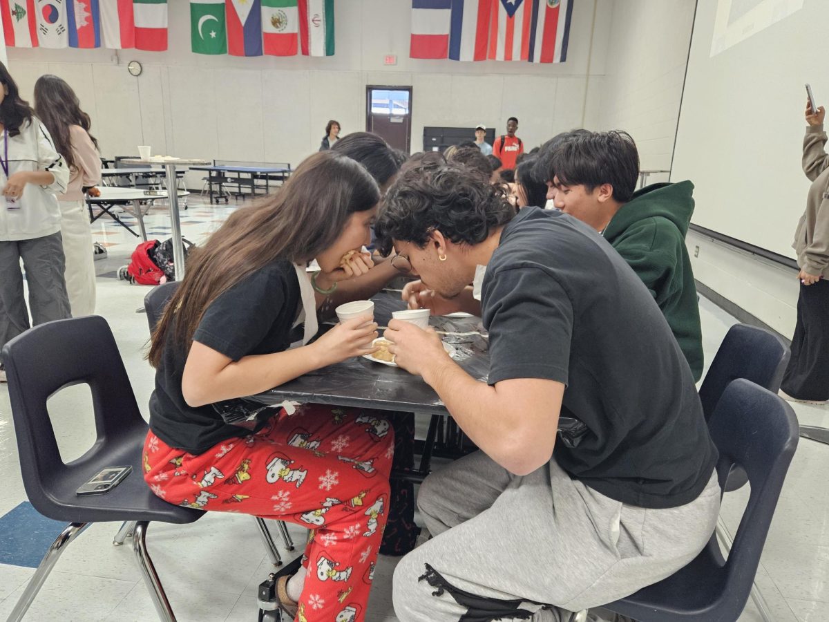 Ready, Steady, Go: Desi club members Chloe Roberts and Georgio Tahtouh pair up for the eating competition. President Meerab Arif and Secretary Sarah Tahtouh go over the rules before beginning the competition. “It was more messy than I thought, but it was fun” Arif said.