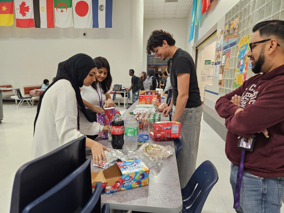 Bring Your Dish: ASA and Desi Club officers set up tables for members to enjoy the food. The cafeteria was cleared out, and the tables were arranged in a “U” shape to create a space for everyone to socialize. “It was a bit difficult setting everything up during fourth period, but we managed to finish in time,” Desi Club president Meerab Arif said.
