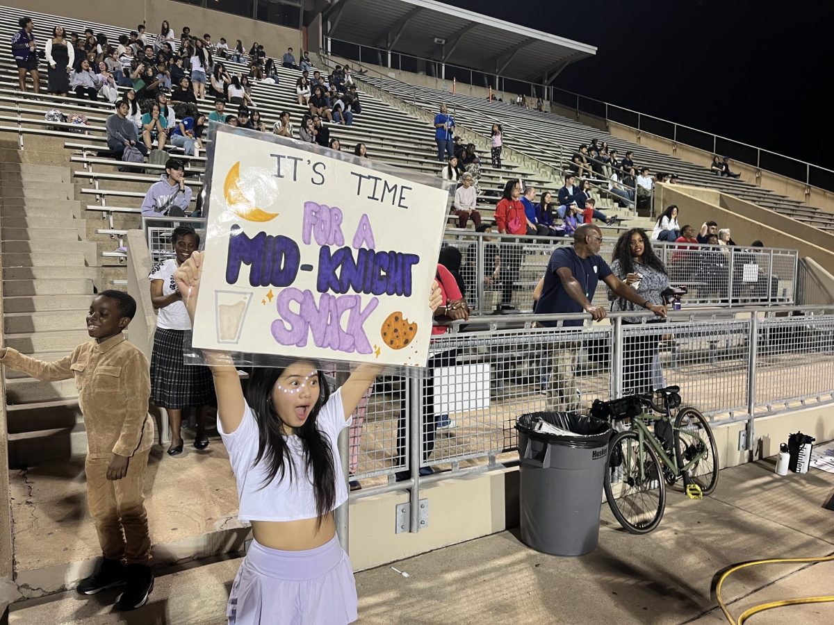 It’s time for a mid-knight snack! Freshman Trang Trinh cheers for football team with poster. It was Trinh’s first Kerr football game. “I knew Kerr was going to win from the start,” Trinh said.