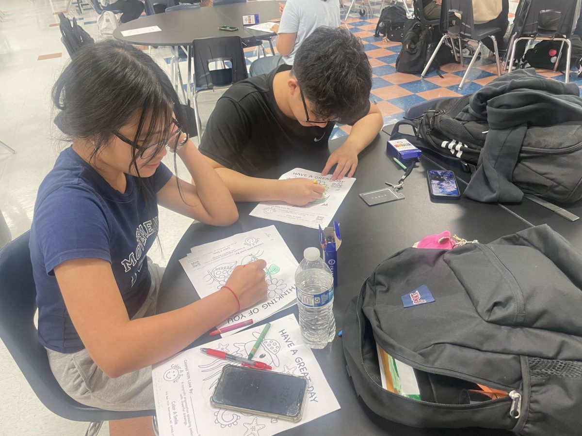 Key Club strikes again! Albert Lam and Gia Ngo spend their November service hours adding color to coloring pages. "This was such a fun experience and a perfect way to unwind after a week of exams," Lam said.