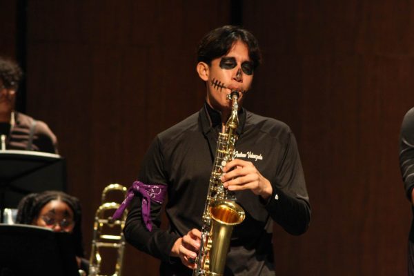 Dressed in Halloween makeup. Jazz Band member Andrew Valenzuela delivers a spirited saxophone performance during the concert. The event featured festive costumes and ensemble pieces, creating a vibrant atmosphere for the audience. Andrew’s look added to the Halloween spirit of the evening. “Playing in costume made the concert even more fun and memorable,” Valenzuela said