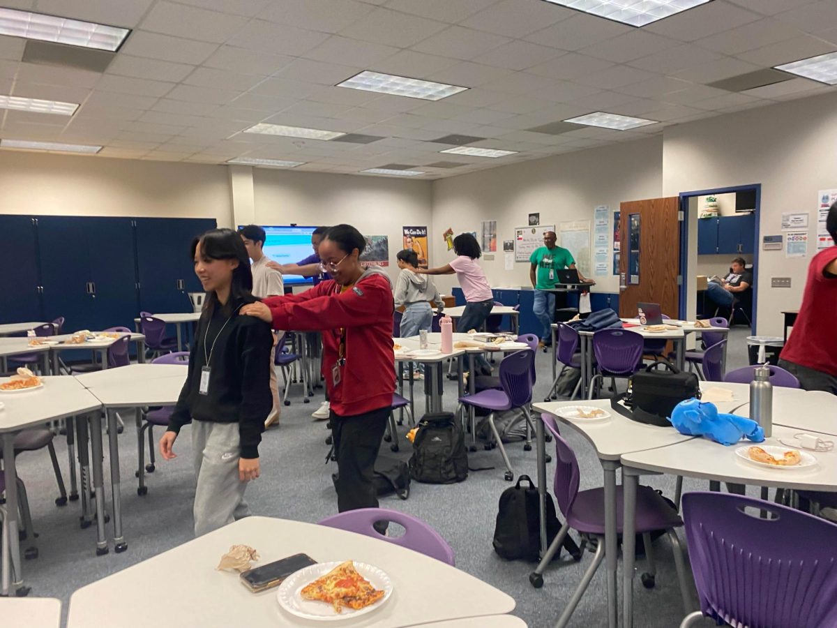 Staying Focused: Students played a game of "Leading the Blind." A player was blindfolded and was led by another student around the room to demonstrate leadership and trust. "Make sure to lead with responsibility,"  Principal Sara Tones said.