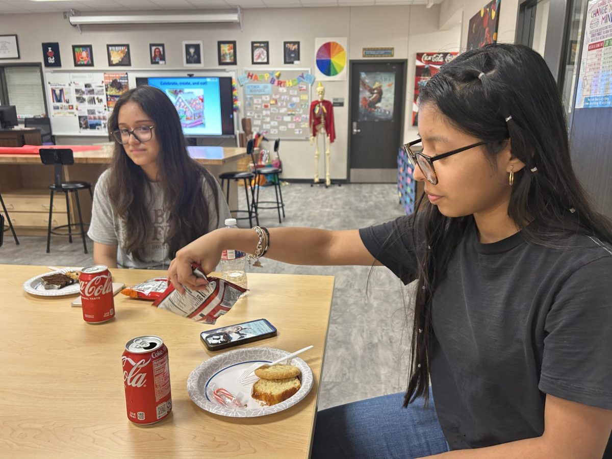 Merry Christmas! Ashley Michelle Chavez Carrillo and Sharon Naomi Piedrasanta enjoy festive treats. They stayed afterschool for NAHS celebration. "This is so delicious, and I’m so happy to be sharing it with my best friend," Piedrasanta said.