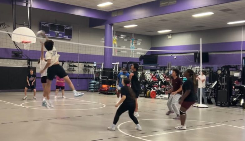 Spike! Senior Khoi Le jumps and blocks the ball over the net. He is a part of 'Need New Name' team and this play scored him 10 points. "My team has practiced a lot and I really hope we win," Khoi said. 