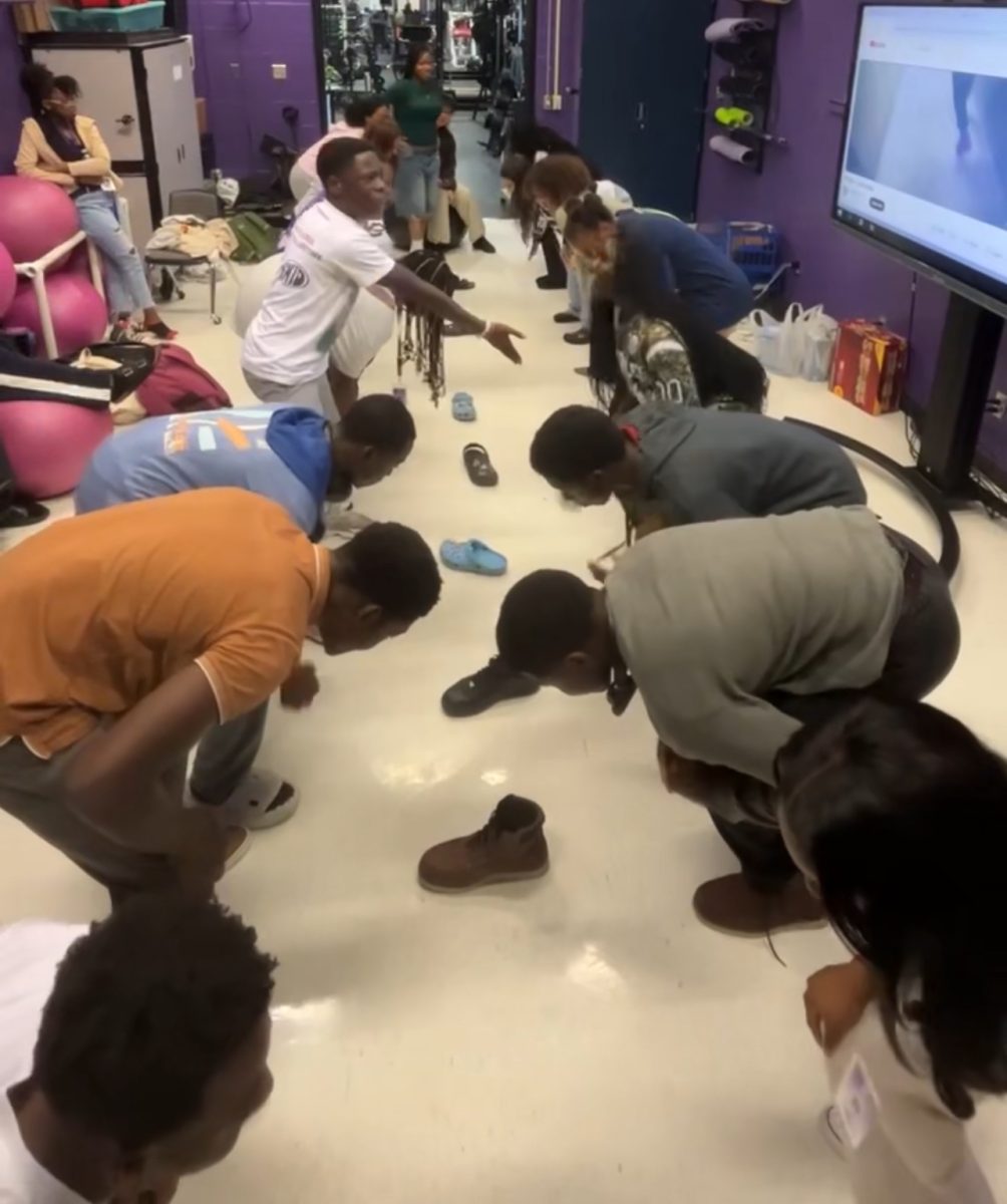 Friendly Competition: Members of the African Students Association engage in a lively round of “Cup in the Middle” using shoes during their November 4th meeting. The game required focus and quick reflexes as participants aimed to grab the right shoe at the perfect moment. This interactive activity added a burst of energy to the gathering, making it much more competitive. “It’s always great to relax and enjoy moments like these together,” Janet Odeoye said.