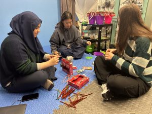 Hard at Work: Manar Al-Gburi, Feliz De Jesus, and Sarah Abi Saab work on decorating the candy cane and tying them to cards. Each Santa Gram was sold for $1. "It was more fun than making Boo Grams," Al-Gburi said.