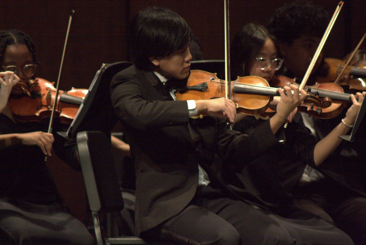 Strings in Harmony: Senior Tony Luong plays as first chair violin during the winter concert. He is a part of Cambiata Orchestra and they performed the Yuletide Celebration. "Playing the violin requires so much practice but it is always a rewarding experience," Luong said. 