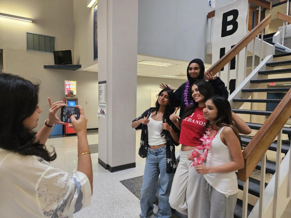 A Tourist At Home: Meerab Arif takes photos of Franzi Desai, Iqra Naveed, Sarah Tahtouh, and Tanisha Patel. They dressed up as tourists for 'Dress Up As A Tourist' Tuesday. "It's fun dressing up, so I'm trying to do it throughout the week," Arif said.