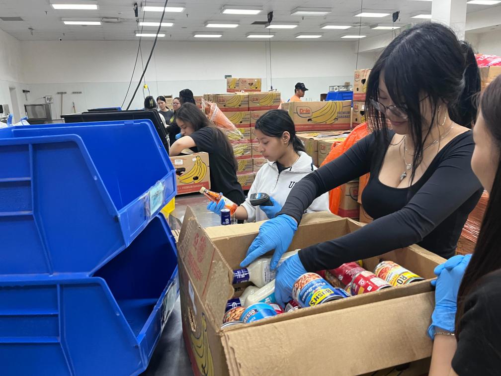 Hard At Work: Ashley Chavez and Katelyn Tieu sort through donated boxes. They scanned the donated goods to see if they were okay to keep, trash, or put in different categories. "It was a lot of work," Tieu said.