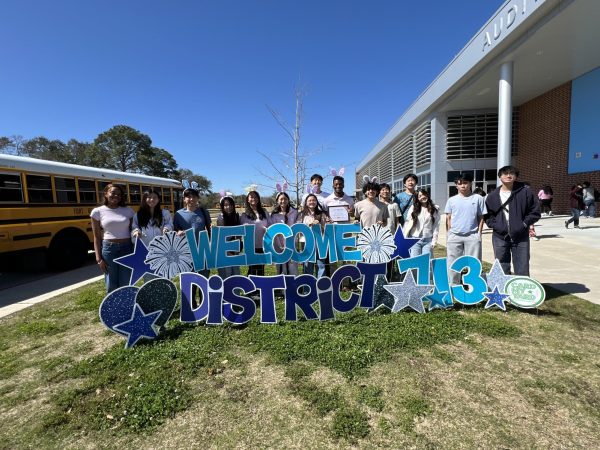 Leadership, Service, and Spirit: Kerr Student Council poses in front of 'Welcome District 713' sign at the spring convention. Attendees spent the whole day networking with other students while electing district officers. "I'm hoping to run and get elected next year," Sophomore Marcos Coronado said. 