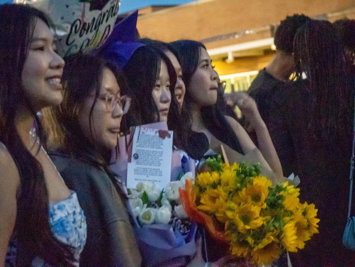 Tina Pham takes photos with her friends and family after graduation.
