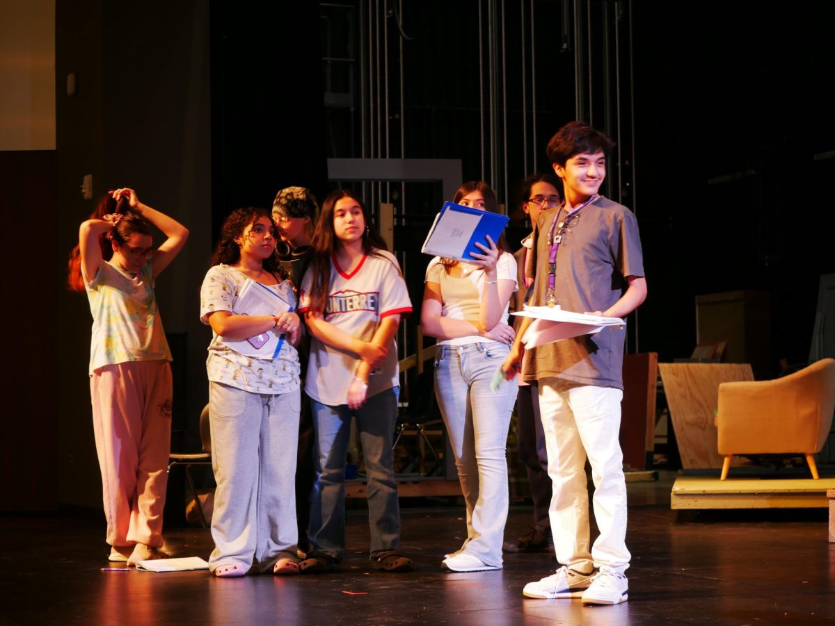 From left to right: cadre members Micheal Morrison (11), Natalia Sorto (11), Isabella Valerio (11), Rebecca
Gibby (10), Rachel Draper (10), Xabi'an Esparza (9), Rohan Sinha (12), and Micheal Uzoechi (11) receive blockings for their scenes in Clue.