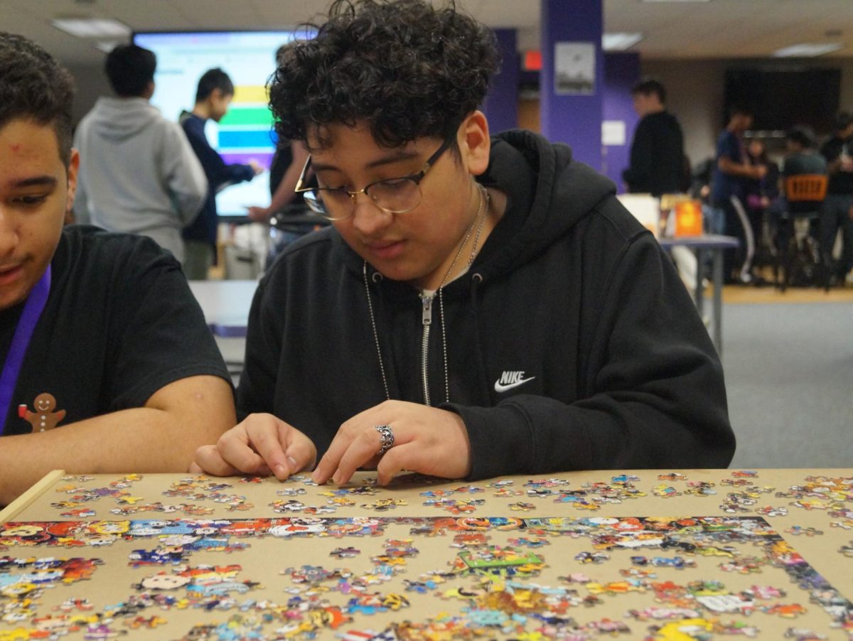 Santiago Martinez builds a Disney Puzzle during his lunch period in the library.