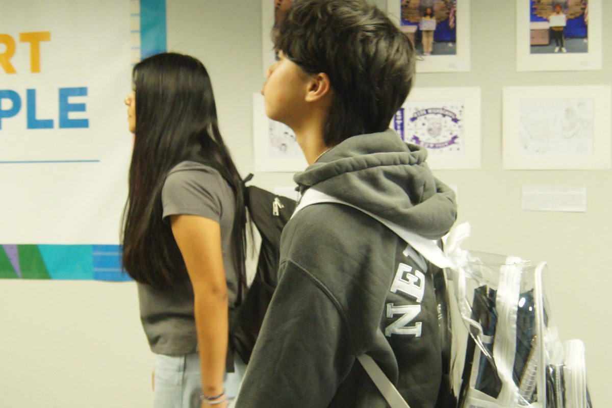 Ariston Nguyen (09) walks in the hallways with
 his clear backpack on.